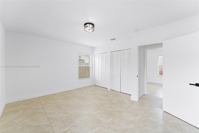 unfurnished bedroom with visible vents and baseboards