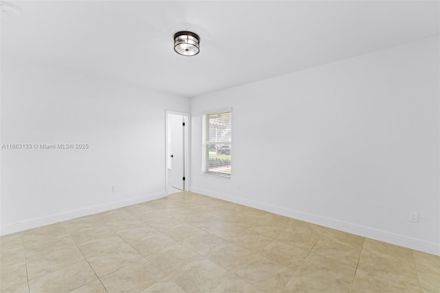 unfurnished room featuring baseboards