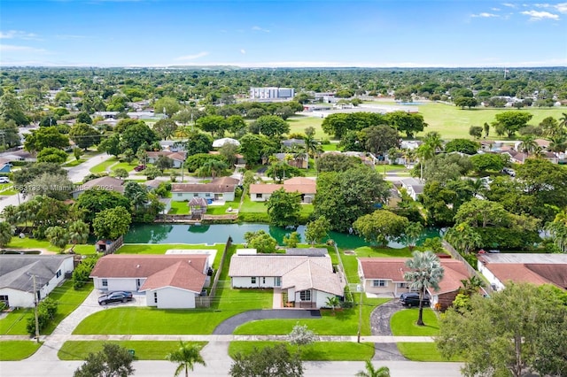 drone / aerial view with a water view and a residential view