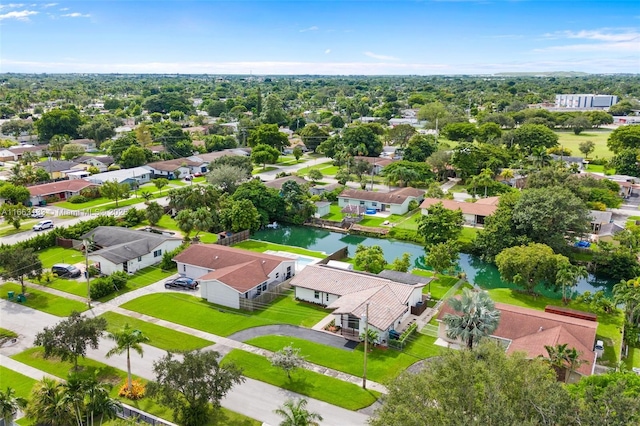 drone / aerial view with a water view and a residential view