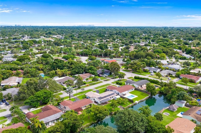 birds eye view of property featuring a water view and a residential view