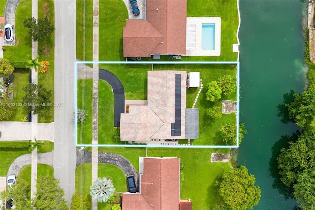 birds eye view of property with a water view