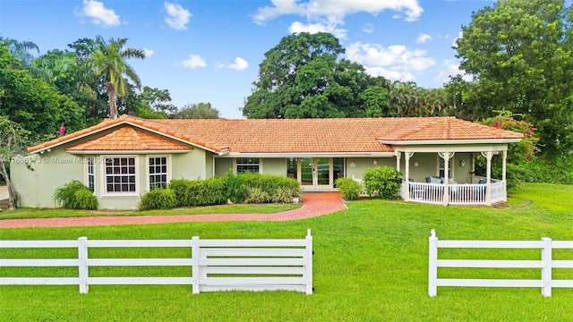 view of front of property with a front yard and french doors