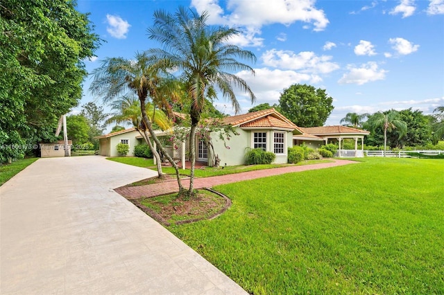 mediterranean / spanish-style house with a front lawn