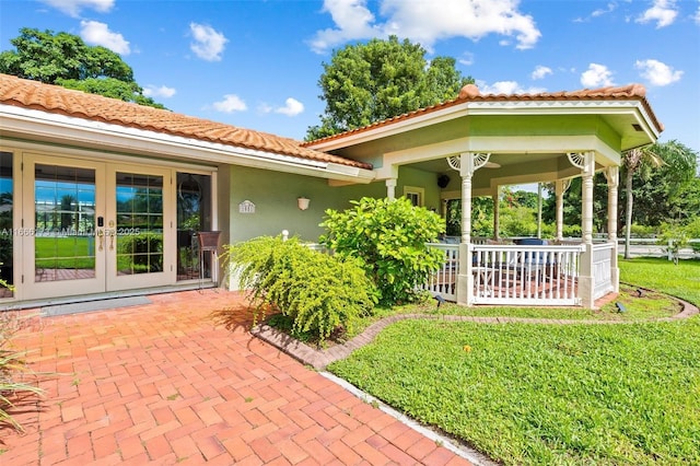 exterior space with french doors and a yard