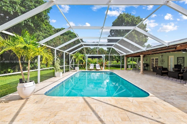 view of pool with an outdoor living space, french doors, a patio, and a lanai