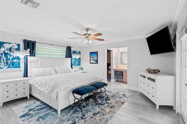 bedroom with ceiling fan, connected bathroom, light hardwood / wood-style flooring, and ornamental molding