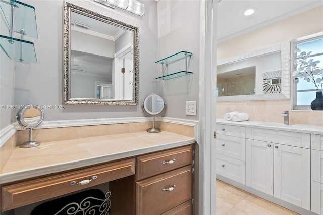 bathroom featuring crown molding and vanity