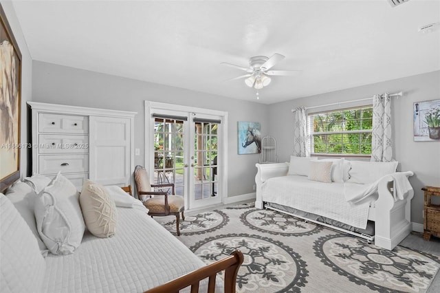 bedroom with ceiling fan, french doors, access to exterior, and multiple windows