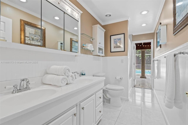 bathroom with crown molding, toilet, tile patterned flooring, and vanity