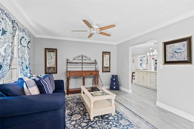 living room with ceiling fan, light hardwood / wood-style flooring, and ornamental molding