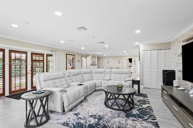 living room featuring ornamental molding, light hardwood / wood-style flooring, and french doors