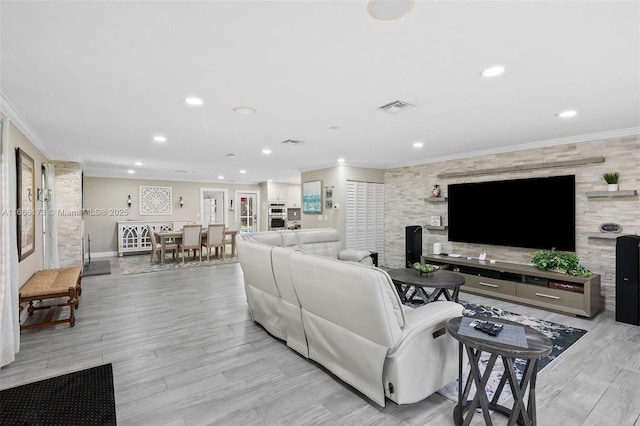 living room featuring crown molding and light hardwood / wood-style floors