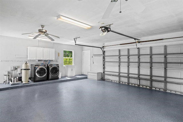 garage featuring ceiling fan, separate washer and dryer, and a garage door opener