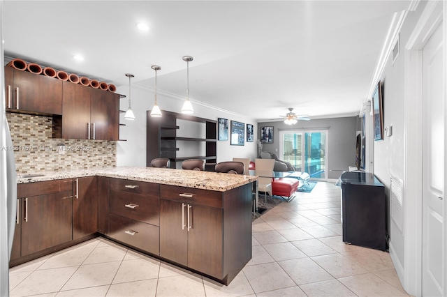 kitchen with dark brown cabinetry, ceiling fan, tasteful backsplash, kitchen peninsula, and crown molding