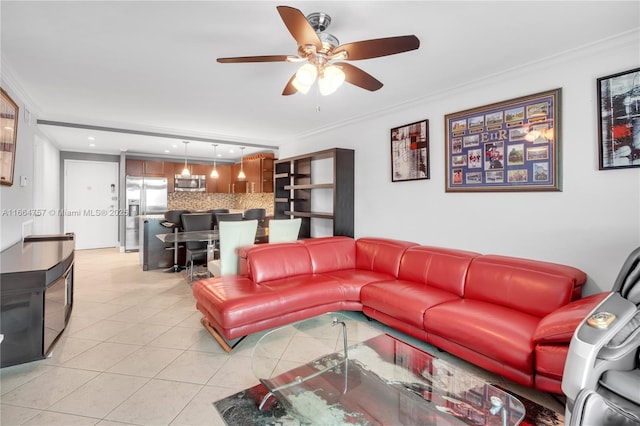 tiled living room with ceiling fan and crown molding