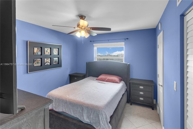 tiled bedroom with ceiling fan