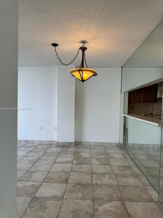 unfurnished room with a textured ceiling