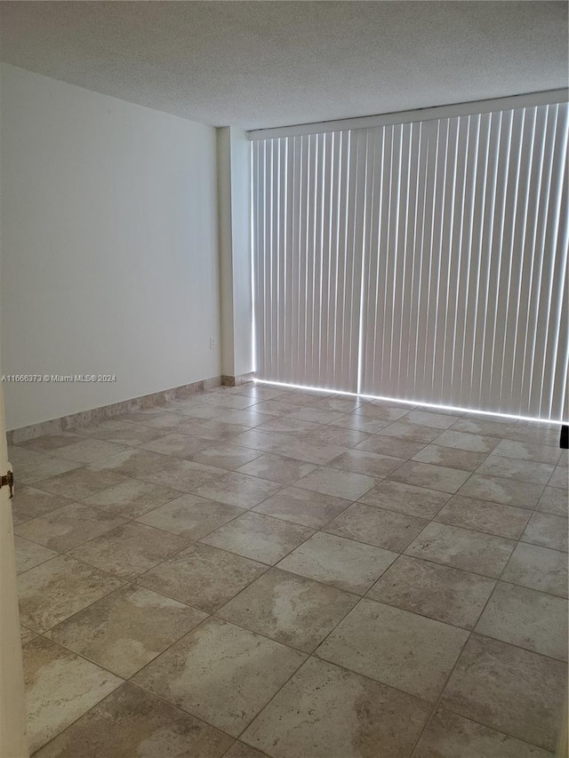 empty room featuring a textured ceiling