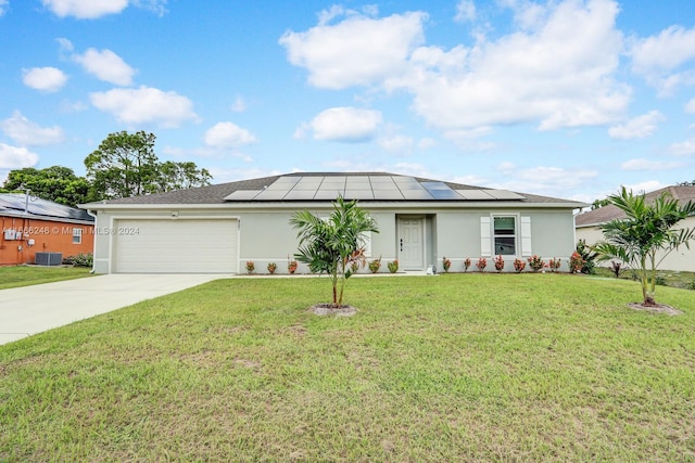 view of front of home with a front yard, a garage, and solar panels