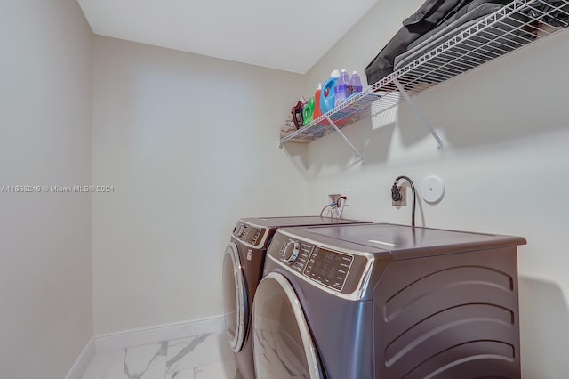 clothes washing area with separate washer and dryer