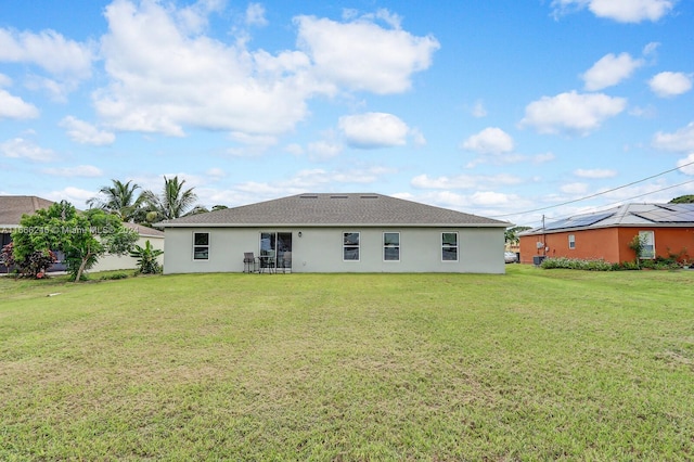 back of property featuring a lawn