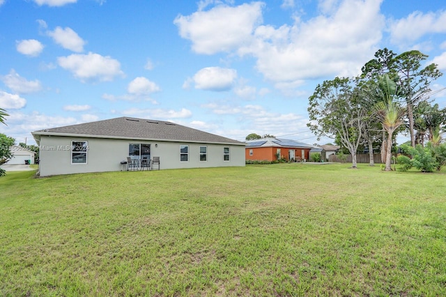 back of house featuring a yard