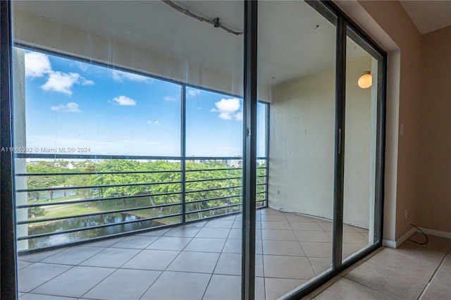 unfurnished sunroom featuring a water view