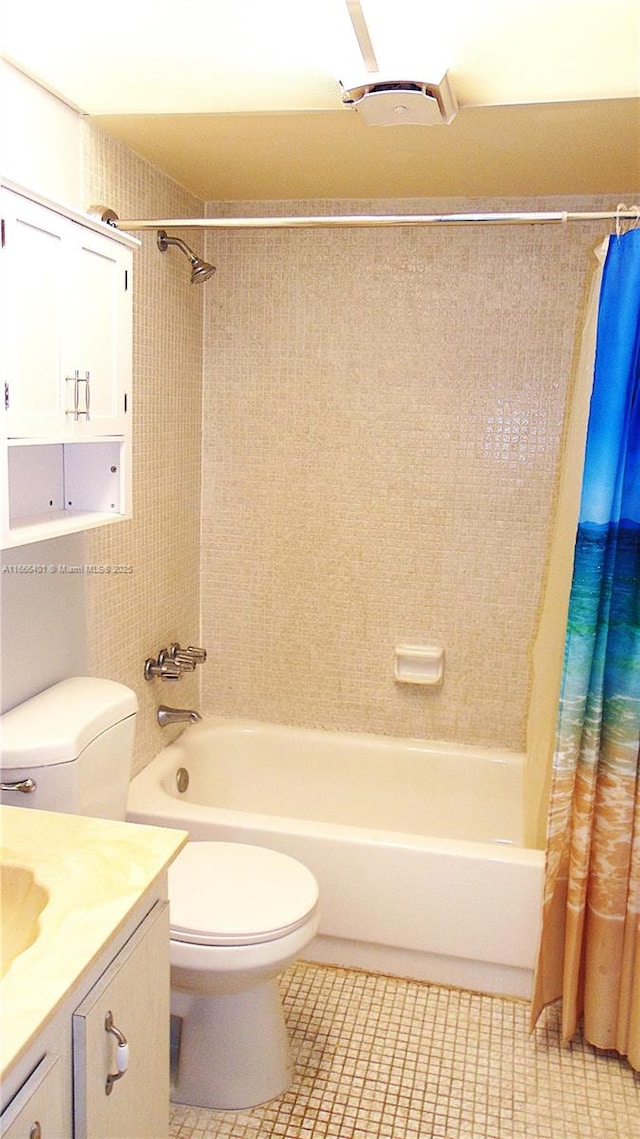 full bathroom with toilet, shower / tub combo with curtain, tile patterned flooring, and vanity