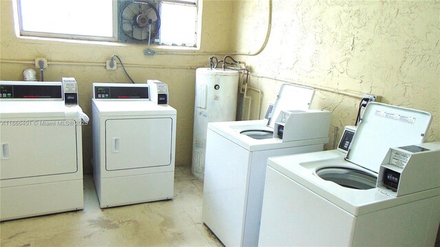 laundry room with electric water heater and washing machine and clothes dryer