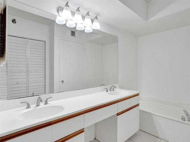 bathroom featuring tile patterned flooring, vanity, and a bathing tub