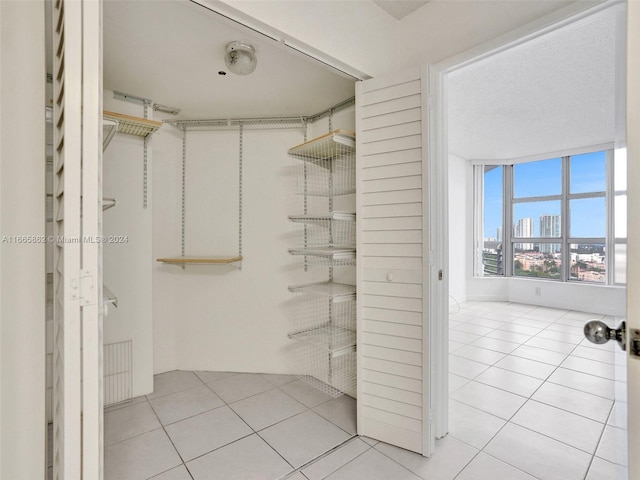 spacious closet with light tile patterned flooring