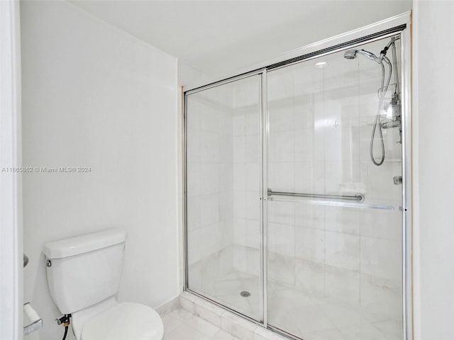 bathroom featuring walk in shower and toilet