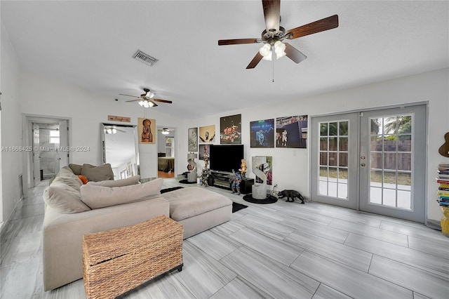 living room with french doors, vaulted ceiling, and ceiling fan