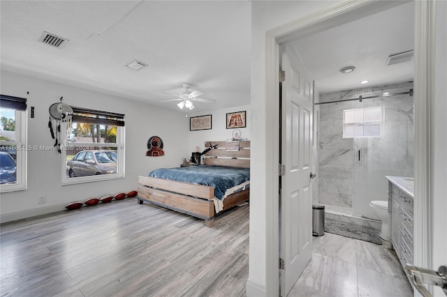 bedroom featuring ceiling fan and ensuite bathroom