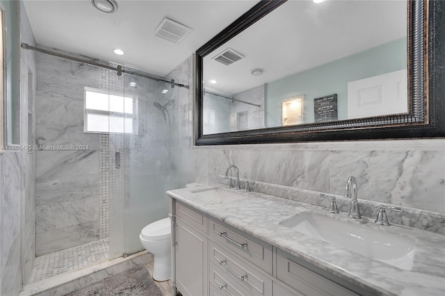 bathroom with vanity, toilet, an enclosed shower, and tile walls