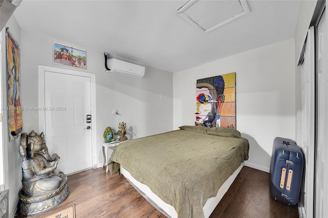 bedroom with a wall mounted air conditioner and dark hardwood / wood-style flooring