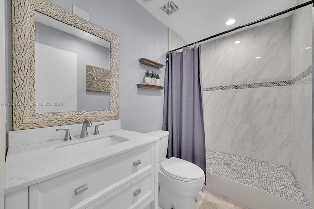 bathroom with toilet, vanity, and a shower with shower curtain