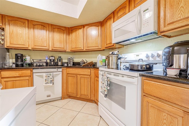 kitchen featuring light tile patterned floors and white appliances