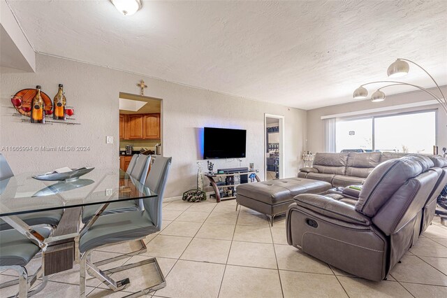 living room with light tile patterned floors and a textured ceiling