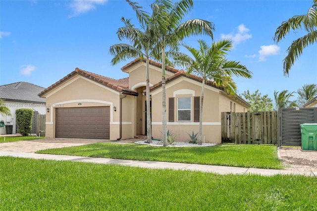 mediterranean / spanish-style home featuring a front lawn and a garage