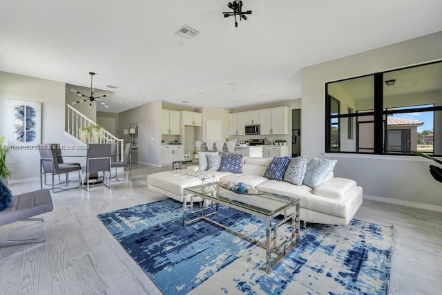 living room featuring light hardwood / wood-style flooring and a chandelier