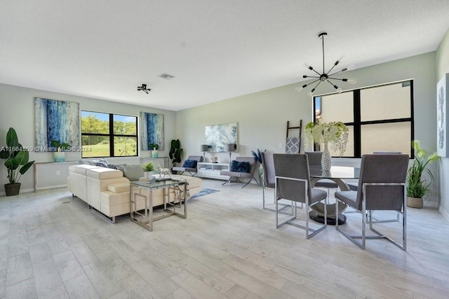 living room featuring a chandelier and light wood-type flooring