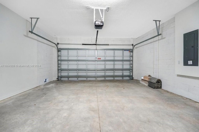 garage featuring a garage door opener and electric panel