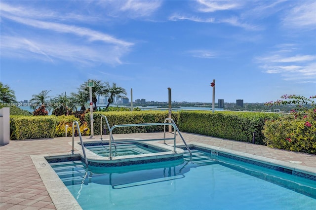 view of pool featuring a water view and a community hot tub