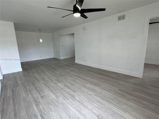 spare room with ceiling fan and hardwood / wood-style flooring