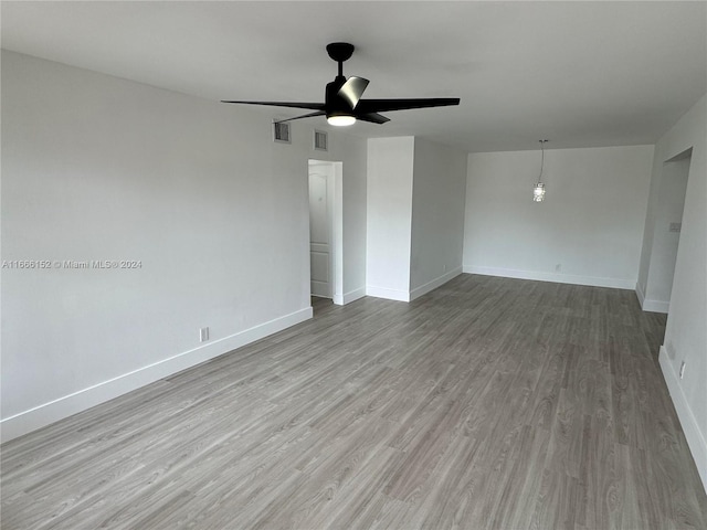 unfurnished room with ceiling fan and light hardwood / wood-style flooring