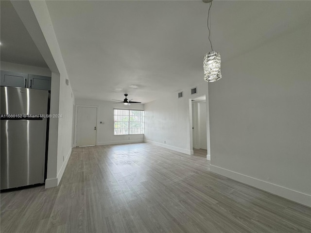 empty room with ceiling fan and hardwood / wood-style floors