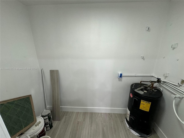 clothes washing area with light hardwood / wood-style floors