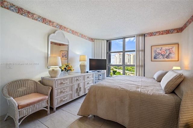 bedroom with a textured ceiling and tile patterned floors